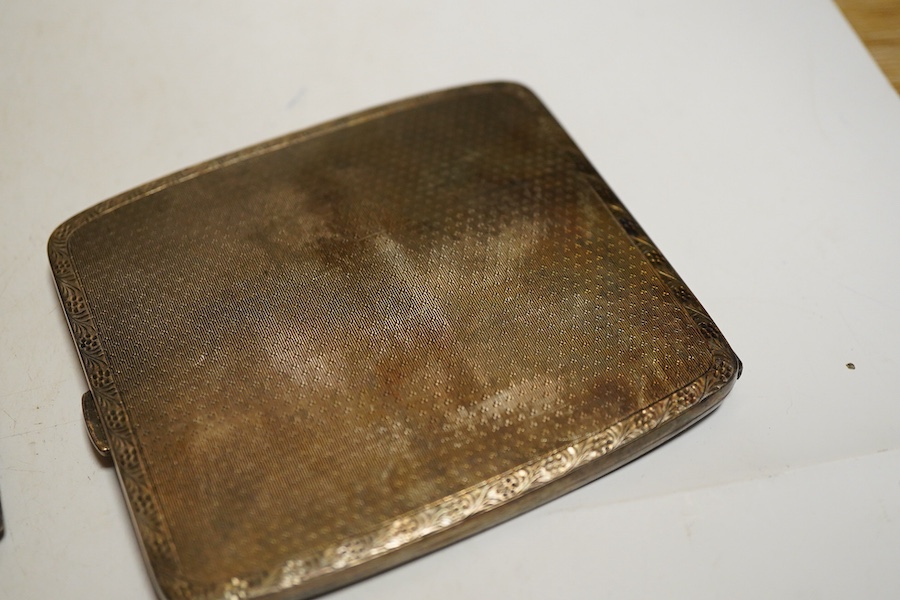 Two George V silver cigarette case, one foliate engraved Birmingham, 1912 the other folaite engraved Birmingham, 1919 Willaim Neale Ltd and a George VI engine turned cigarette case, weight approx. 14.43ozt (3)